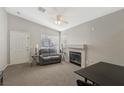 Cozy living room with neutral colors, a ceiling fan, and a fireplace at 4130 Lucas Ave, Las Vegas, NV 89120