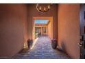 Elegant entryway featuring stone flooring, textured walls, and a chandelier at 47 Grand Masters Dr, Las Vegas, NV 89141