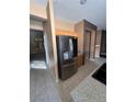 Spacious kitchen showcases stainless steel refrigerator and tiled floors at 4824 Quartz Crest St, North Las Vegas, NV 89081