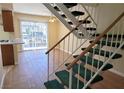 An open living space, showing stairs, wood flooring, and a sliding door to the outside at 530 Sellers Pl, Henderson, NV 89011