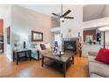 Cozy living room featuring a fireplace, comfortable seating, and a ceiling fan at 5528 Apache Wells Way, Las Vegas, NV 89130