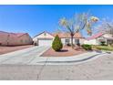 Inviting single-level home with a well-maintained yard and convenient two-car garage at 5927 Tropical Palm Ct, North Las Vegas, NV 89031