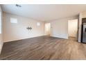 Neutral living room with wood-look floors and ample windows for natural light at 6129 Rose Springs Ave, Las Vegas, NV 89130