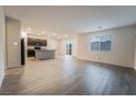 Spacious living room with wood-look floors and sliding glass doors to backyard at 6129 Rose Springs Ave, Las Vegas, NV 89130