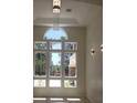 Bright living space with multi-pane windows offering picturesque views of the lush tropical landscaping at 7261 Obannon Dr, Las Vegas, NV 89117