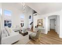 Spacious living room with vaulted ceilings, large windows, and stylish contemporary decor at 7832 Desert Candle Way, Las Vegas, NV 89128