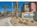 Exterior view of the Serenade Palms Condominium Homes signage surrounded by palm trees and desert landscaping at 8000 Badura Ave # 1020, Las Vegas, NV 89113