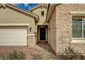 Close up exterior view with stone facade and desert landscaping at 864 Klamath Springs St, Henderson, NV 89011