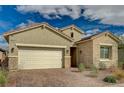 Inviting exterior showcasing a two-car garage, desert landscaping, and attractive stonework at 864 Klamath Springs St, Henderson, NV 89011