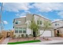 Contemporary two-story home with drought-tolerant landscaping and a paver driveway at 9675 Bold Skye Ave, Las Vegas, NV 89166