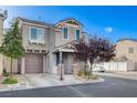 Charming two-story home with desert landscaping, and a brown garage door at 10429 Amber Night St, Las Vegas, NV 89183