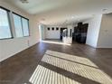 The kitchen boasts stainless steel appliances, dark cabinets, granite countertops and a tiled floor at 10715 York Manor Ave, Las Vegas, NV 89166