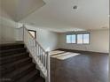 The living room features tile floors, natural light from multiple windows, and staircase access at 10715 York Manor Ave, Las Vegas, NV 89166