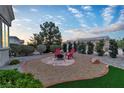Serene backyard features a cozy fire pit area and lovely landscaping at 10801 Clarion Ln, Las Vegas, NV 89134