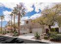Attractive home with a three-car garage, well-manicured front yard, and desert landscaping at 11241 Golden Chestnut Pl, Las Vegas, NV 89135