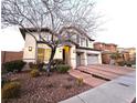 Inviting two-story home featuring a well-manicured front yard and an attached two-car garage at 11660 Intervale Rd, Las Vegas, NV 89135
