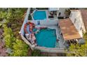 This aerial view showcases a backyard pool and spa area that has a waterfall feature at 1229 Triumph Ct, Las Vegas, NV 89117