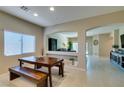 Inviting dining area featuring a wooden table and bench seating illuminated by natural light at 124 Strone St, Henderson, NV 89012