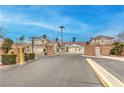 Community entrance with secure gates and manicured landscaping, offering privacy and curb appeal at 1970 Jasper Creek Pl, Las Vegas, NV 89123