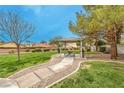 Community picnic area featuring shaded seating and lush green space, perfect for outdoor gatherings at 1970 Jasper Creek Pl, Las Vegas, NV 89123