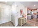 Inviting entryway showcasing stylish flooring, a decorative cabinet, and access to the kitchen at 201 Biscotti St # Lot 20, North Las Vegas, NV 89084
