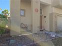 Charming front porch with desert landscape, walkway, and seating at 2012 Nightrider Dr, Las Vegas, NV 89134