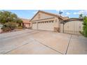 Two-car garage with stone accents and an enclosed front courtyard at 213 Red Coral Dr, Henderson, NV 89002