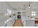 Modern kitchen with stainless appliances, quartz counters, island seating, and ample cabinet space at 2837 Reynolds Ave, North Las Vegas, NV 89030