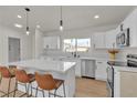 Well-lit kitchen featuring stainless appliances, barstool seating, and a view from the window at 2837 Reynolds Ave, North Las Vegas, NV 89030