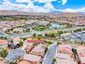 Beautiful aerial view of community featuring a lake, desert landscape, and mountain backdrop at 3767 Westeros Landing Ave, Las Vegas, NV 89141