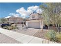 Charming two-story home featuring a desert-landscaped yard, brick driveway, and attached two-car garage at 457 Cornelius Kelly Ave, Henderson, NV 89011