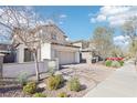 Charming two-story home featuring a desert-landscaped yard, brick driveway, and attached two-car garage at 457 Cornelius Kelly Ave, Henderson, NV 89011