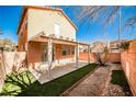 A serene backyard featuring a covered patio and low-maintenance artificial turf at 4817 Eureka Diamond Ct, Las Vegas, NV 89139