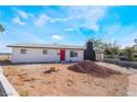 Single-story home featuring a red front door, flat roof, and a rock chimney at 4980 Becky Pl, Las Vegas, NV 89120