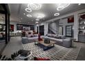 Open-concept living area with modern sofas, stylish rug, and seamless flow to the kitchen and staircase at 545 Overlook Rim Dr, Henderson, NV 89012