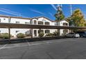 A bright two-story condo building with covered parking and manicured bushes at 5655 E Sahara Ave # 1060, Las Vegas, NV 89142