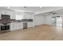 Open concept kitchen with stainless steel appliances and view of dining area at 613 Kings Pl, Boulder City, NV 89005