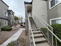 View of exterior stairs leading to units, surrounded by landscaped grounds and walkways at 6160 Rumrill St # 207, Las Vegas, NV 89113