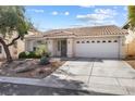 Charming single-story home with a well-manicured front yard and two-car garage at 9581 Ancala Hollow Ct, Las Vegas, NV 89148