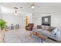 Bright living room with tile floors, high ceilings and comfortable seating at 9581 Ancala Hollow Ct, Las Vegas, NV 89148