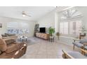 Spacious living room features tile flooring, vaulted ceilings, and large windows at 9581 Ancala Hollow Ct, Las Vegas, NV 89148