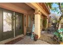 Inviting front porch with decorative door, plants, stone flooring, and a 'welcome' sign at 1013 Baronet Dr, Las Vegas, NV 89138