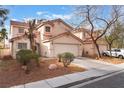 Charming home features a well-maintained front yard, desert landscaping, and an attached two-car garage at 1017 Cliffbrook Hedge Ave, North Las Vegas, NV 89081