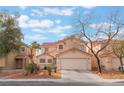 Beautiful two-story home features a well-maintained front yard, desert landscaping, and an attached two-car garage at 1017 Cliffbrook Hedge Ave, North Las Vegas, NV 89081