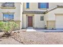 Close up of home's front door showing neutral stucco facade and minimal landscaping at 1021 Gary Carmena Ave, North Las Vegas, NV 89081