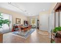 Elegant dining room with tiled flooring, a large window, and a stylish dining set at 10704 Warrior Ct, Las Vegas, NV 89135