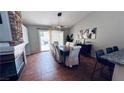 Bright dining room with a fireplace and a glass sliding door that provides natural light at 124 Beach Oak Ave, Henderson, NV 89002
