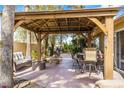 Covered patio with a full outdoor kitchen and dining and seating area, perfect for entertaining at 124 Beach Oak Ave, Henderson, NV 89002