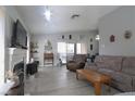 Inviting living room featuring neutral walls, hardwood floors, fireplace, and cozy furniture at 1312 Georgia Ave # D, Boulder City, NV 89005