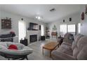 Inviting living room featuring neutral walls, hardwood floors, fireplace, and cozy furniture at 1312 Georgia Ave # D, Boulder City, NV 89005